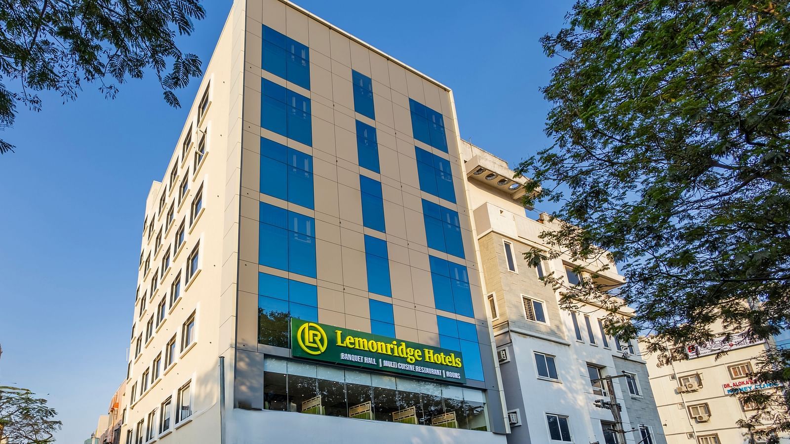 Lemonridge Hotels, KPHB | Exterior daytime view of the hotel building. Street level perspective with signage.
